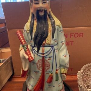 Ceramic Figurine with Scroll and Tassels